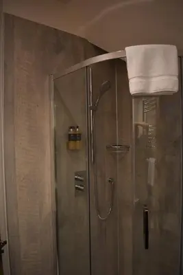a shower in a bathroom with a towel on top at Orchy Bank House in Dalmally