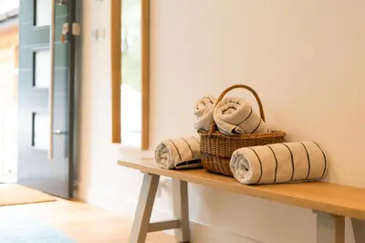 a basket of towels sitting on a table in a room at The Heronry Hideaway with luxury hot tub in Ballachulish