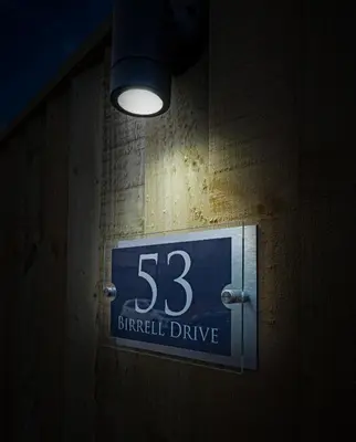 a sign on the side of a wall with a light at Pitcorthie House in Dunfermline