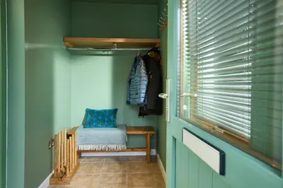 a room with a blue door with a bench and a window at Tanamuir, overlooking Loch Fyne, Strachur in Cairndow