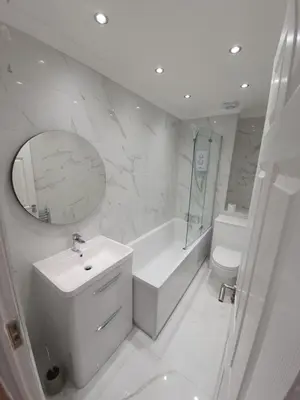 a bathroom with a sink and a toilet and a mirror at Modern house close to Glasgow Green in Glasgow