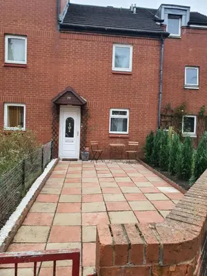 a brick house with a patio in front of it at Modern house close to Glasgow Green in Glasgow