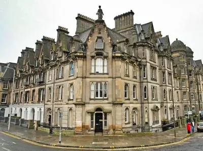 a large building on the corner of a street at Castle Terrace 1 Bed Apartment Looking onto Edinburgh Castle - Sleeps upto 4 in Edinburgh