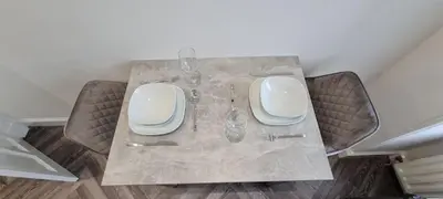 a table with two vases and glasses on it at Castle Terrace 1 Bed Apartment Looking onto Edinburgh Castle - Sleeps upto 4 in Edinburgh