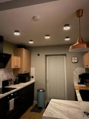 a kitchen with a sink and a clock on the ceiling at Lovely 3 bed with jacuzzi, close to airport, driveway, wifi in Edinburgh