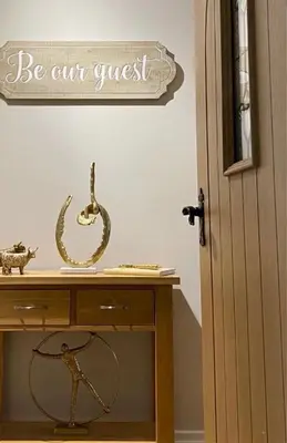a desk with a sign that says be our guest at Menstrie Castle Stay in Stirling