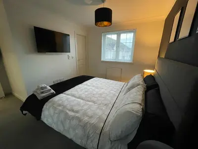 a bedroom with a bed and a flat screen tv at Niche View in Irvine