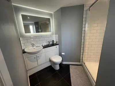 a bathroom with a toilet and a sink and a shower at Niche View in Irvine