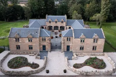 an aerial view of a large house with a yard at Stunning Edinburgh 1820s stables converted studio in Edinburgh