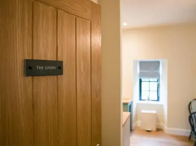 a door with a sign that reads the cason at Stunning Edinburgh 1820s stables converted studio in Edinburgh