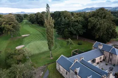 an aerial view of a house and a golf course at Stunning Edinburgh 1820s stables converted house in Ratho