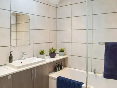 a bathroom with a sink and a mirror at The Cottage in Girvan