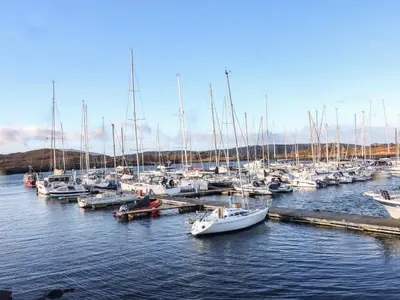 a bunch of boats docked in a harbor at Kelpie in Lochgilphead