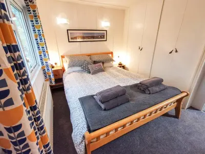a bedroom with a bed with towels on it at Kelpie in Lochgilphead