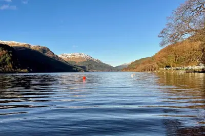 a view of a lake with mountains in the background at Kevington Cottage in Hunters Quay