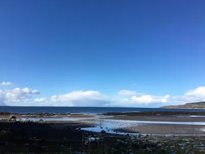 a view of the ocean from a beach at Grand top floor apartment in the Royal Bank House in Maybole