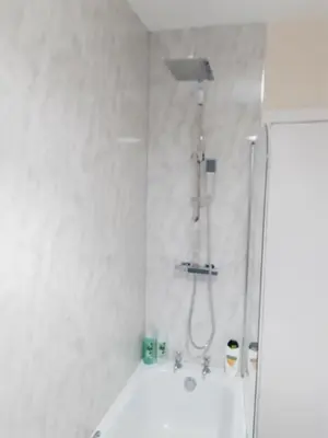 a white bathroom with a shower and a tub at Carvetii - Vincent House - Large 3 bedroom apartment with on-site parking in Fife