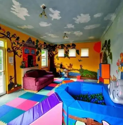 a living room with a play room with a toy floor at The Rabbit Hill Holiday Home in Ballantrae