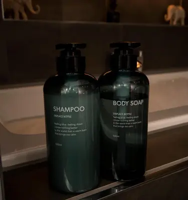 two bottles of shampoo and soap sitting on a sink at Station View, Dunblane in Dunblane