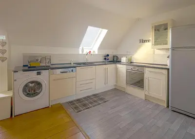 a kitchen with a washing machine and a sink at Castle View - Home from Home in Stirling