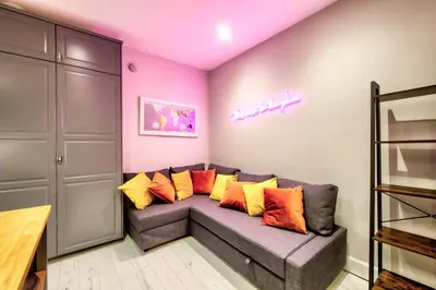 a living room with a couch with colorful pillows at Stylish & Spacious 3 Bedroom Apt in Finnieston, West End in Glasgow