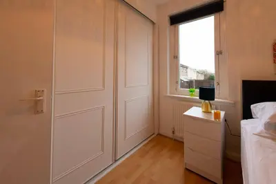a bedroom with a closet with a door and a window at PREMIER - Chapel House with Driveway! in Cleland