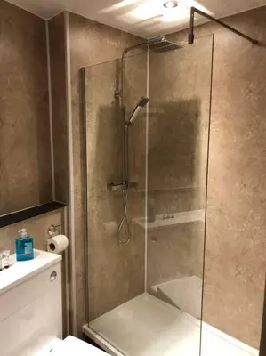 a shower with a glass door in a bathroom at Pier Head in Largs