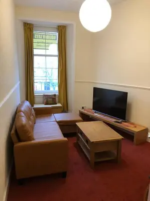 a living room with a couch and a flat screen tv at Pier Head in Largs