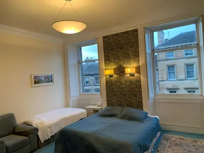 a room with two beds and a window at 2 Chester St in Edinburgh