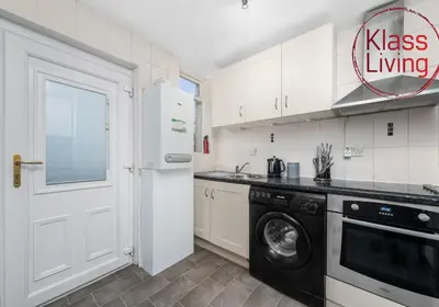 a kitchen with a washer and dryer in it at Garturk Apartment by Klass Living Coatbridge in Coatbridge