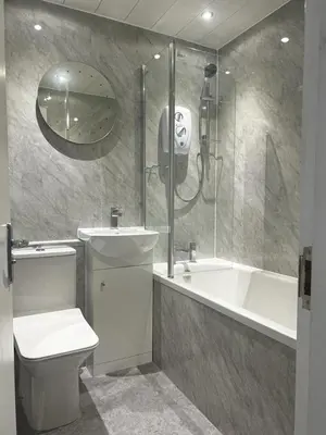 a bathroom with a toilet and a shower and a sink at The Trossachs Apartment in Doune