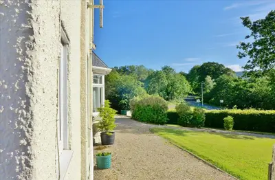 a view from a window of a house with a garden at Allandale House in Brodick