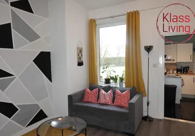 a living room with a couch and a window at Mossend Apartment by Klass Living Bellshill in Mossend