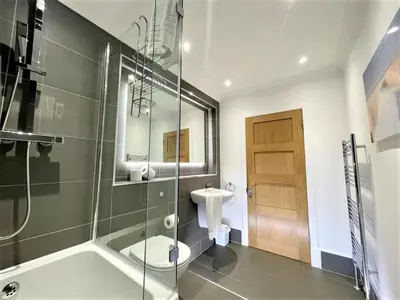 a bathroom with a shower and a toilet and a sink at Elite 3 Bed New Town Apt with Private Walled Garden in Edinburgh