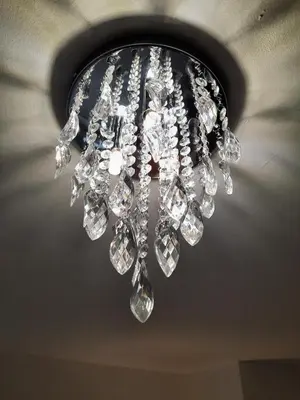 a chandelier is hanging from a ceiling at Pond View Upper in Airdrie