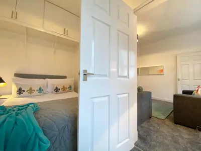 a door leading to a bedroom with a bed at Gladsmuir House in Glasgow