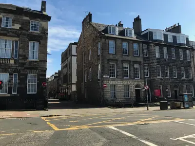 an empty city street with two large brick buildings at Edinburgh Deluxe Duplex with Garage in Edinburgh