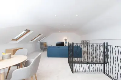a living room with a table and chairs and a couch at Edinburgh Deluxe Duplex with Garage in Edinburgh