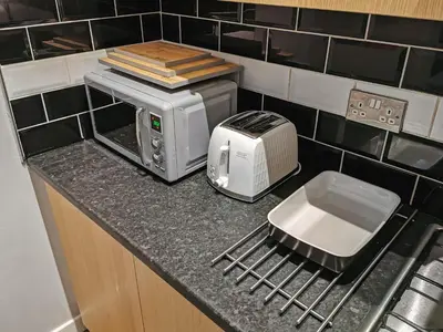 a kitchen counter with a microwave and a toaster at 3 bed apartment in the heart of westend of Glasgow in Glasgow