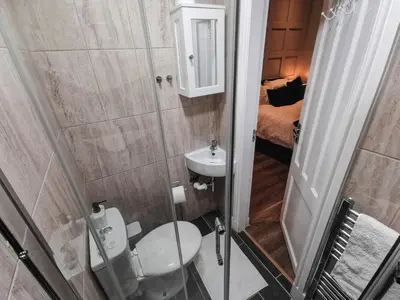 a small bathroom with a toilet and a sink at 3 bed apartment in the heart of westend of Glasgow in Glasgow