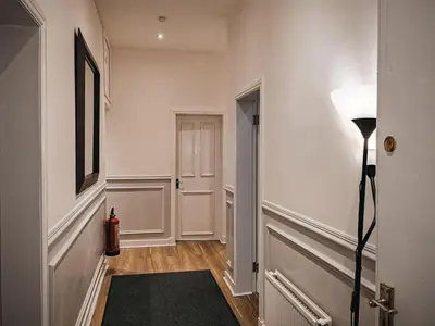a hallway with a floor lamp and a door at 3 bed apartment in the heart of westend of Glasgow in Glasgow