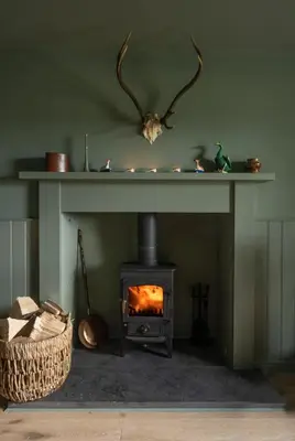 a fireplace in a living room with a stove at Stormont House in Keilour