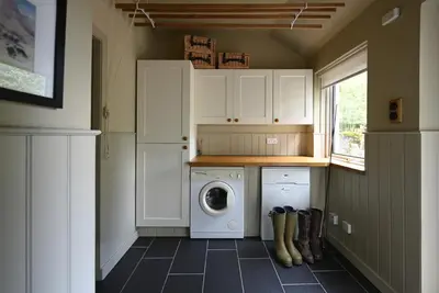 a laundry room with a washer and dryer in it at Stormont House in Keilour