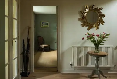 a hallway with a mirror and a table with flowers at Stormont House in Keilour