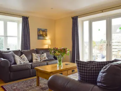 a living room with a couch and a table at White Wisp in Kinross