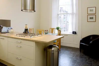 a kitchen with a counter and a stove top oven at Stylish Central Edinburgh Apartment in Edinburgh