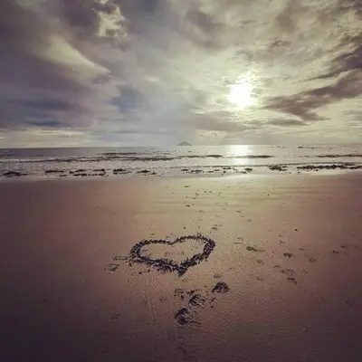 a heart drawn in the sand on a beach at Stunning Riverside Town House with views Ayrshire in Girvan
