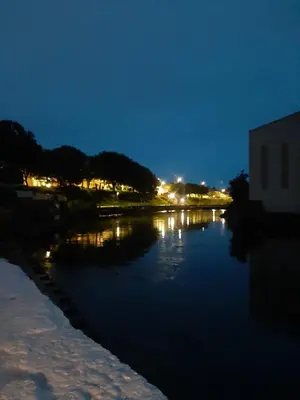 a view of a river at night with lights at Stunning Riverside Town House with views Ayrshire in Girvan