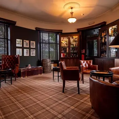 a lobby with chairs and tables in a room at Enterkine Country House Resort in Annbank