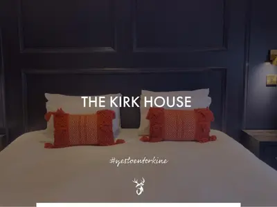 a bed with two pillows with the kirk house on it at Enterkine Country House Resort in Annbank